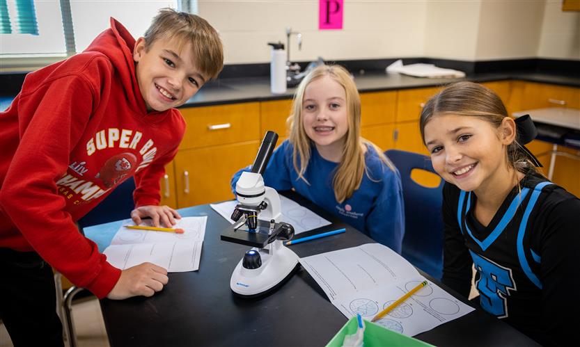 Students use microscopes in science class
